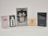 three boxes of perfume and a box of soap on a white surface