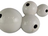 three white balls with black spots on them
