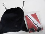 a black bag with a remote control and other items in it