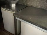 a kitchen with a sink and a refrigerator in it