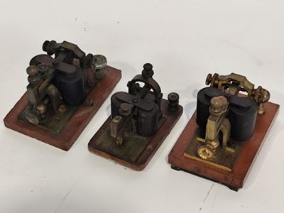 three small metal figurines of a man on a motorcycle and a man on a motorbike