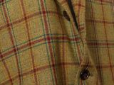 the jacket is brown and blue with a red and blue checkered pattern