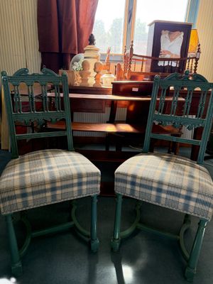 two chairs sitting next to each other in front of a window