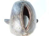 a metal object with a hole in it on a white surface