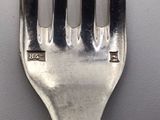 a silver fork with a silver handle on a table
