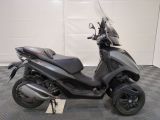 a motorcycle that is parked on a checkered floor