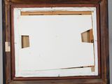 an old picture frame with a piece of paper sticking out of it