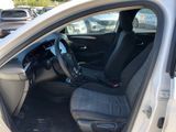 the interior of a car with the door open and the driver ' s seat up