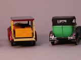 four toy cars that are lined up in a row
