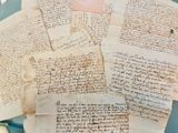 a pile of old papers sitting on top of a table