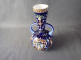 a blue vase with a gold and blue design on it