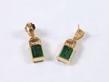 pair of emerald and gold earrings on a white background