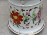 un petit vase blanc orné d'un motif floral