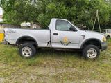 a white truck that is parked in the grass