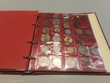 a red book with a bunch of coins inside of it