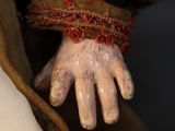 a close up of a person ' s hand with white paint on it