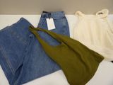 two pairs of jeans and a t - shirt are sitting on a table