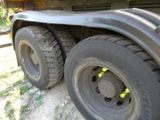 a close up of a truck tire on a dirt road