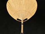 a wooden fan that is on a white table