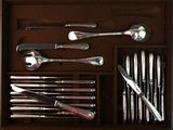 a wooden box filled with silverware and utensils