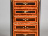 an image of a small chest of drawers with gold trimmings