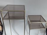pair of glass and metal side tables