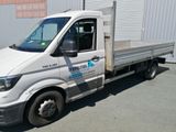 a white truck with a flat bed parked in front of a building