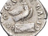 a close up of a coin with a bird on top of it