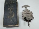 a book and a bottle opener sitting on a table