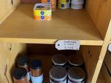 a wooden shelf with jars and jars of food on it