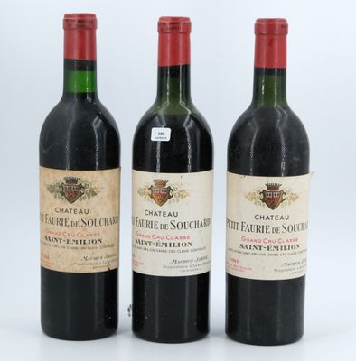 three bottles of red wine sit side by side on a white surface