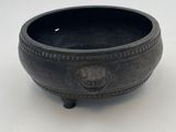 a black bowl sitting on a white table