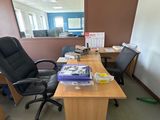 a desk with a chair and a mirror in an office