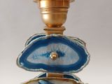 a picture of a blue and white lamp with a gold base