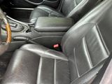 a picture of the interior of a car with black leather seats
