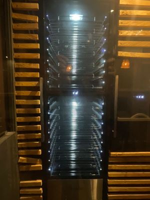 a stainless steel oven that has many racks of food inside of it