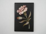 painting of a pink carnation on a black background on a white wall