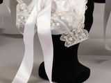 a mannequin with a veil and a white ribbon on it