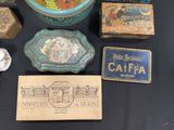 many different types of tins and boxes on the table