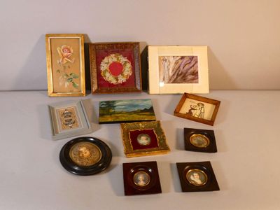 a lot of framed pictures on a white table