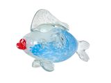 a glass fish that is sitting on a white surface
