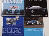 four books on a table with a yellow car and a blue car