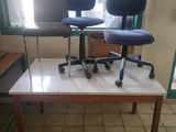 two chairs sitting on a table in a room