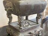 a large metal pot sitting on top of a black table
