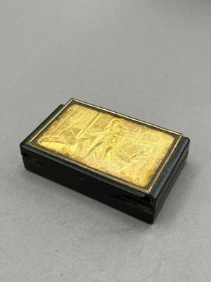 a gold and black box sitting on top of a table
