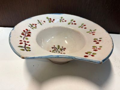 a white bowl with a red and green design on it