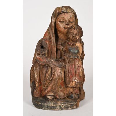 an old wooden statue of a woman holding a child