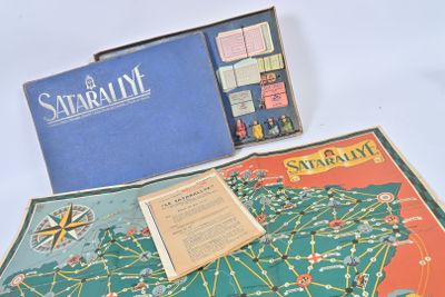 a board game set up on a table next to a book