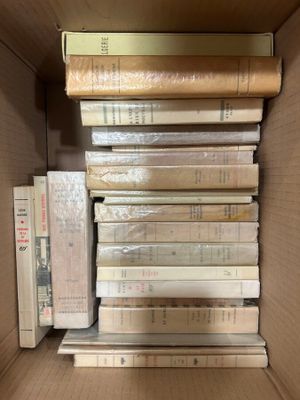 a box full of books that are stacked on top of each other