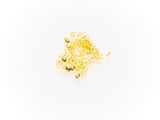a pile of gold nuggies on a white surface